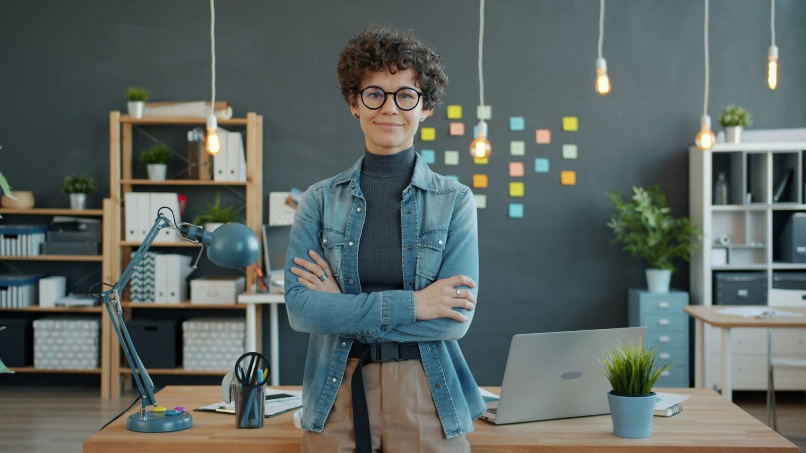 Confident professional woman standing in a modern office, representing career opportunities and progress for women in the workplace.